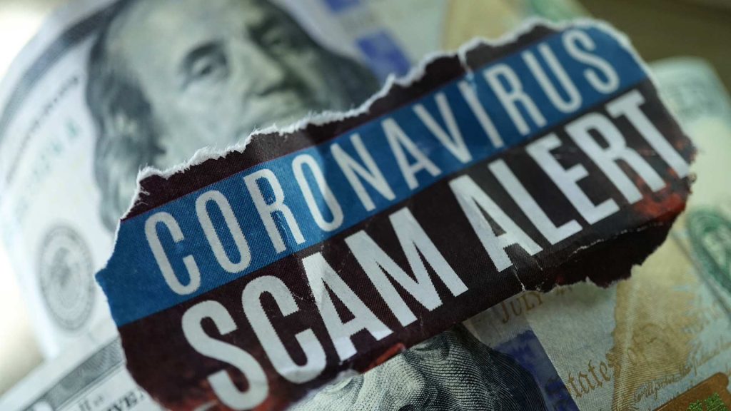 Coronavirus scam alert on dollar bill